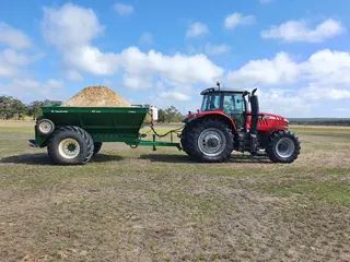 Tractor and loaded fertiliser spreader