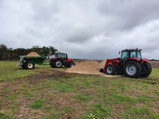 Tractor and spreading equipment in the paddock